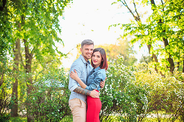 Image showing Happy young couple at park standing and laughing on the bright sunny day