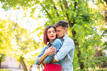 Image showing Happy young couple at park standing and laughing on the bright sunny day