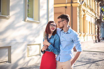 Image showing Happy young couple standing at street of city and laughing on the bright sunny day