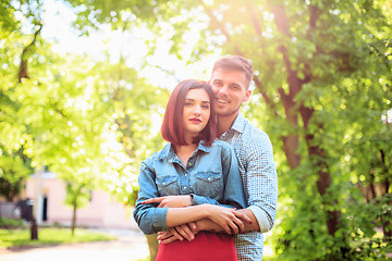 Image showing Happy young couple at park standing and laughing on the bright sunny day