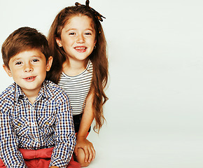 Image showing little cute boy and girl hugging playing on white background, ha