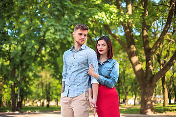 Image showing Happy young couple at park standing and laughing on the bright sunny day