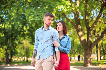 Image showing Happy young couple at park standing and laughing on the bright sunny day