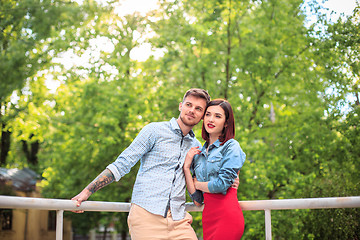 Image showing Happy young couple at park standing and laughing on the bright sunny day