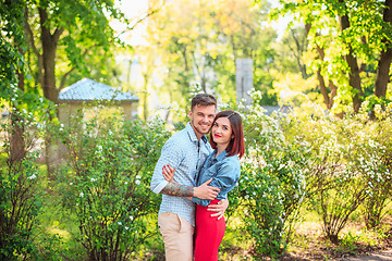 Image showing Happy young couple at park standing and laughing on the bright sunny day