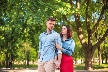 Image showing Happy young couple at park standing and laughing on the bright sunny day