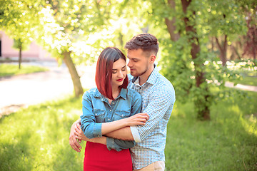 Image showing Happy young couple at park standing and laughing on the bright sunny day