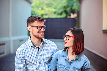 Image showing Happy young couple standing at street of city and laughing on the bright sunny day