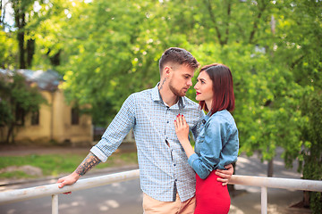 Image showing Happy young couple at park standing and laughing on the bright sunny day