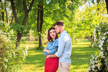 Image showing Happy young couple at park standing and laughing on the bright sunny day