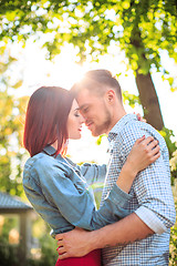 Image showing Happy young couple at park standing and laughing on the bright sunny day