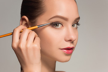 Image showing Beautiful female eyes with make-up and brush