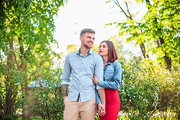 Image showing Happy young couple at park standing and laughing on the bright sunny day