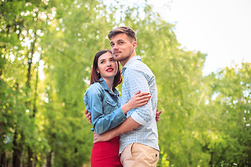 Image showing Happy young couple at park standing and laughing on the bright sunny day