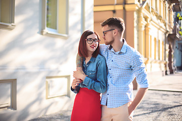 Image showing Happy young couple standing at street of city and laughing on the bright sunny day