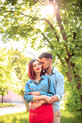 Image showing Happy young couple at park standing and laughing on the bright sunny day