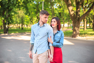 Image showing Happy young couple at park standing and laughing on the bright sunny day