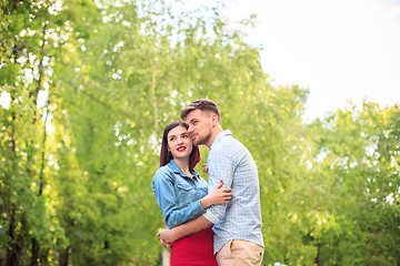 Image showing Happy young couple at park standing and laughing on the bright sunny day