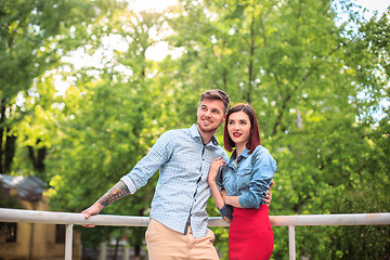 Image showing Happy young couple at park standing and laughing on the bright sunny day