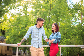 Image showing Happy young couple at park standing and laughing on the bright sunny day