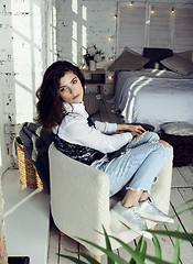 Image showing young pretty woman in her bedroom sitting in chair, lifestyle people concept