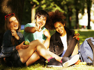 Image showing cute group of teenages at the building of university with books 