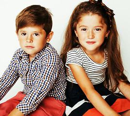 Image showing little cute boy and girl hugging playing on white background, ha