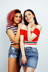 Image showing lifestyle people concept: two pretty stylish modern hipster teen girl having fun together, diverse nation mixed races, happy smiling making selfie closeup