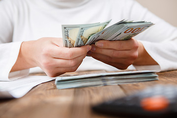 Image showing Hands counting money, close up