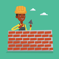 Image showing Bricklayer working with spatula and brick.