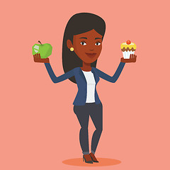 Image showing Woman choosing between apple and cupcake.