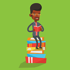 Image showing Student sitting on huge pile of books.