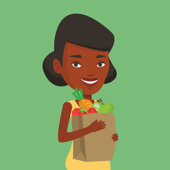 Image showing Happy woman holding grocery shopping bag.