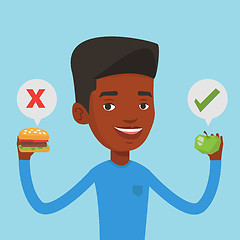 Image showing Man choosing between hamburger and cupcake.