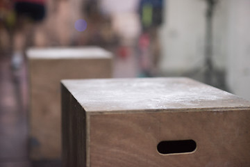 Image showing black woman is performing box jumps at gym