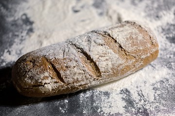 Image showing Fully baked bread on flour