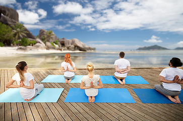 Image showing group of people making yoga exercises outdoors