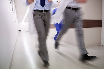 Image showing close up of medics or doctors running at hospital