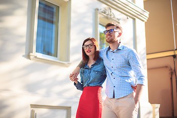 Image showing Happy young couple standing at street of city and laughing on the bright sunny day