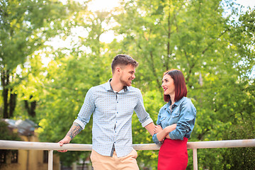 Image showing Happy young couple at park standing and laughing on the bright sunny day