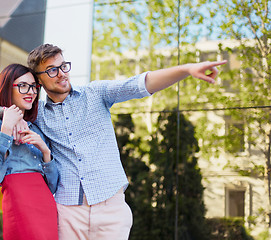 Image showing Happy young couple standing at street of city and laughing on the bright sunny day