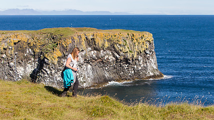 Image showing Woman on the edge of the cliff - Iceland