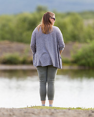 Image showing Woman standing at the riverside