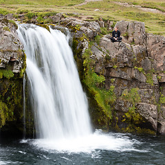 Image showing Kirkjufellsfoss waterfall near the Kirkjufell mountain, woman en