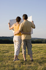 Image showing Couple with map in a meadow