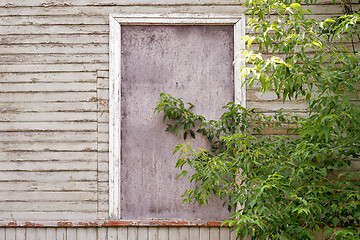 Image showing abandoned wooden house with boarded up windows