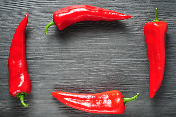 Image showing Frame made of sweet red Kapia peppers on a dark shale