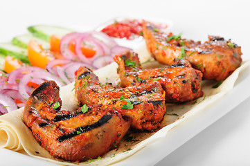 Image showing Grilled lamb tongues with fresh vegetables salad