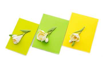 Image showing Close up of three yellow envelope with flowers