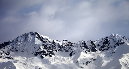 Image showing Panoramic view on sunlight winter mountains and sky with clouds